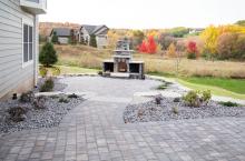 A paver patio with outdoor fireplace 
