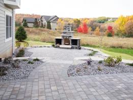 A paver patio with outdoor fireplace 